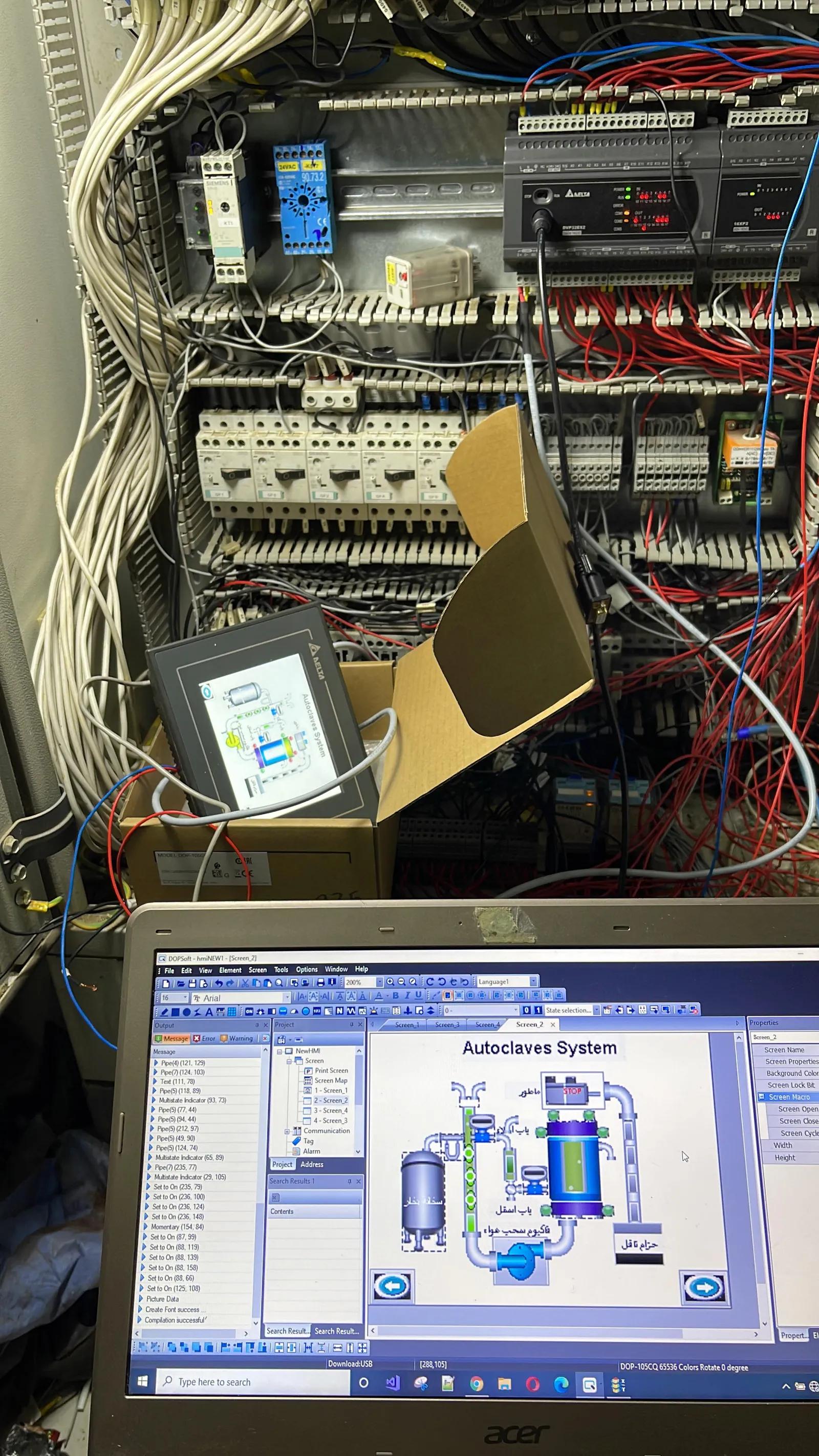 Open control panel showing PLC wiring, with a laptop displaying the SCADA screen